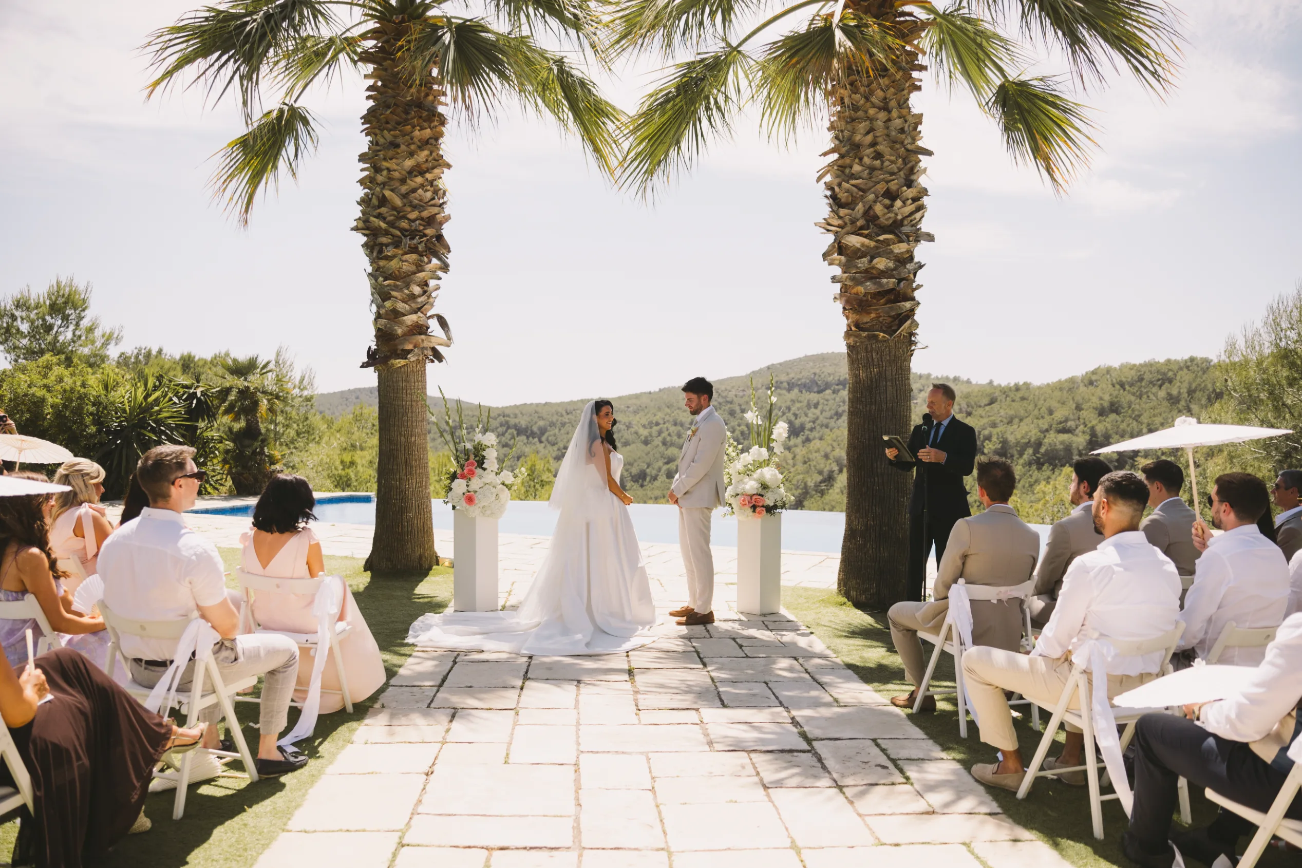 Bride and groom at their outdoor ceremony beneath the palms at Casa Nova Estate