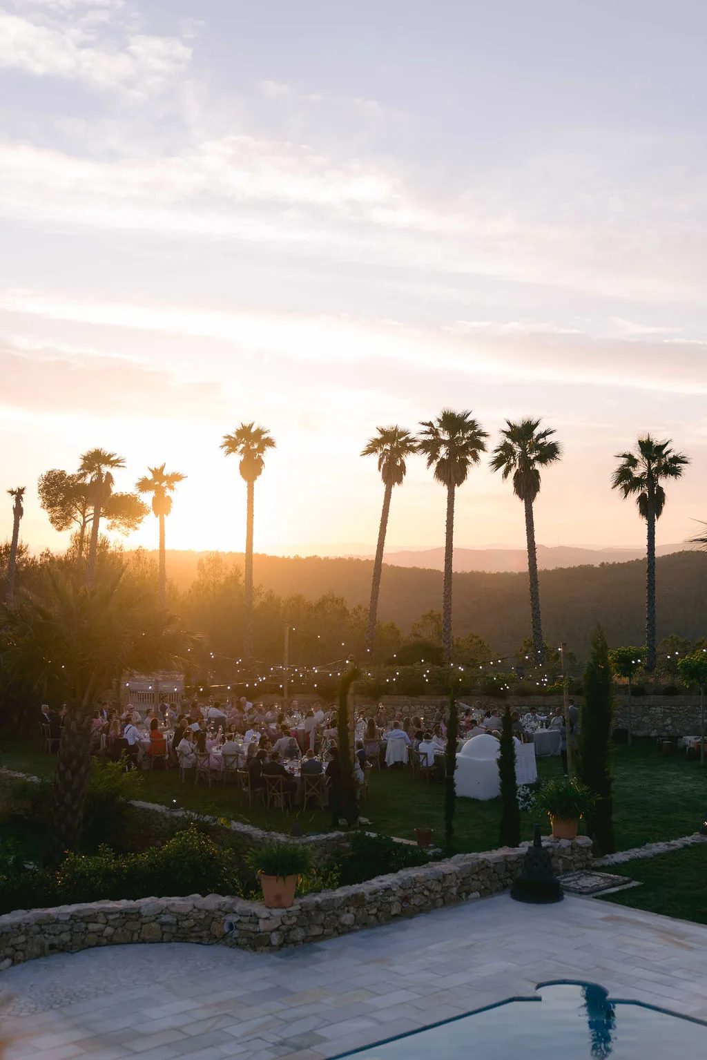Sunset over the palm trees and wedding reception at Villa Alcazar del Garraf