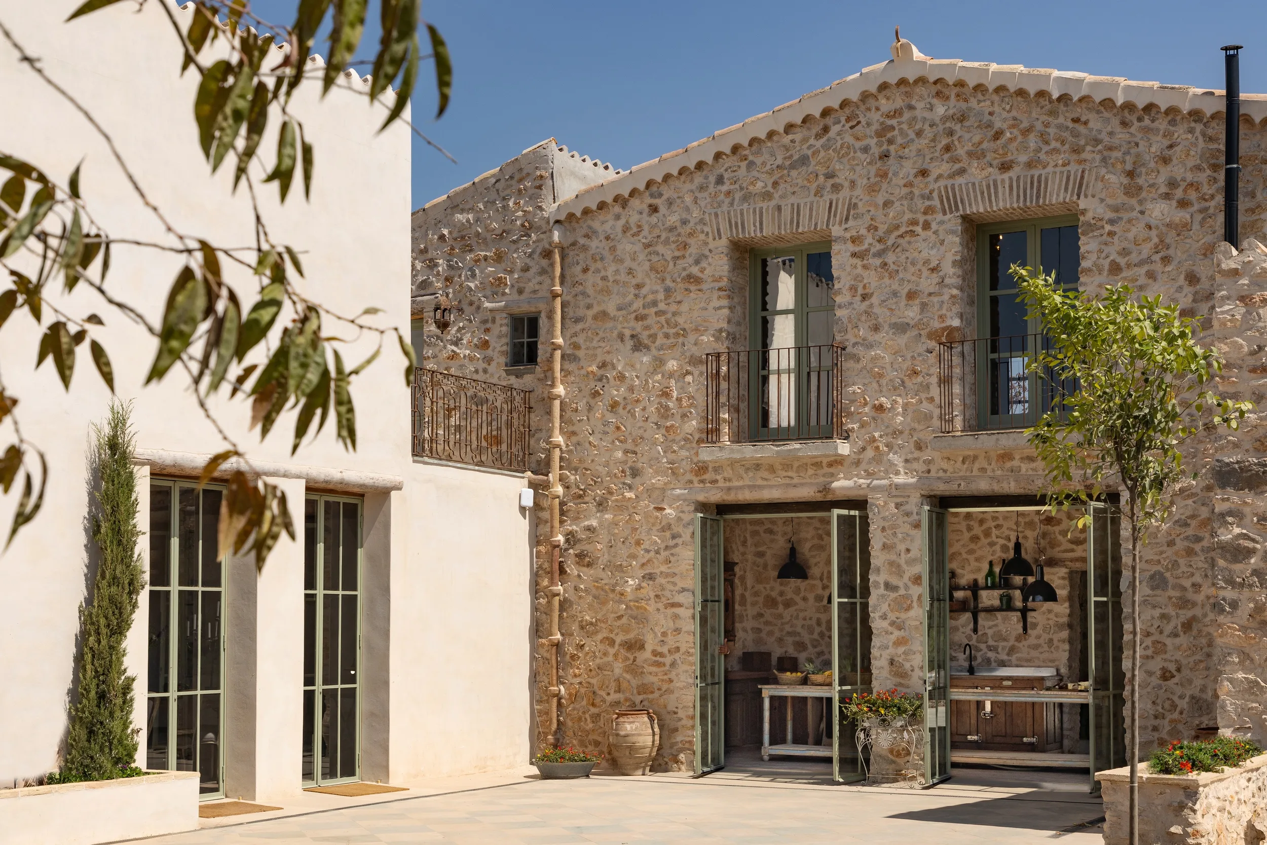 Stone exterior and wrought-iron balcony at Mansion Los Naranjos
